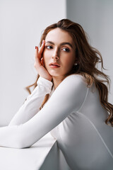 Close up portrait of sensual pretty young woman in white clothes