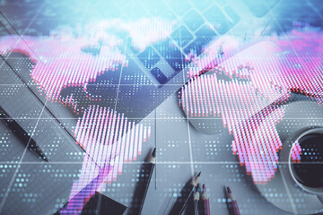 Business theme hologram drawings over computer on the desktop background. Top view. Multi exposure. Concept of international connections.