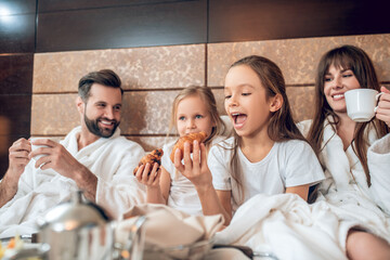 Girls eating croissants and looking excited