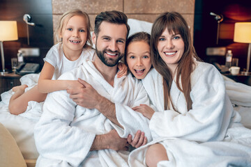 Family in white robes smiling and looking wonderful