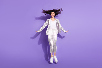 Full size photo of young cheerful girl happy positive smile have fun jump up isolated over purple color background