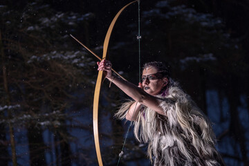 viking girl with a bow in the wood