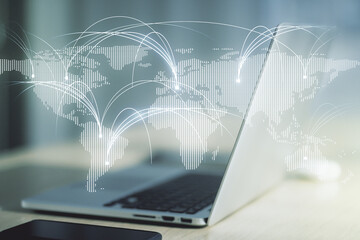 Double exposure of abstract digital world map with connections on laptop background, research and strategy concept