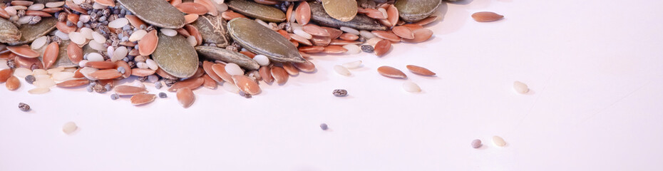 A mix of edible seeds on a white kitchen table