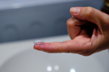 A woman's hands with a contact lens. Vision Correction and Health Care. Contact Lenses.
