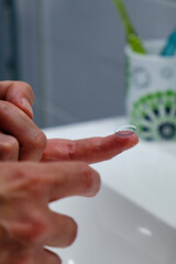 A woman's hands with a contact lens. Vision Correction and Health Care. Contact Lenses.