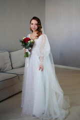 Fototapeta na wymiar bride with long hair, with bouquet of flowers, in white wedding dress in room. 