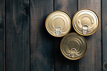 Closed food tin cans on dark background