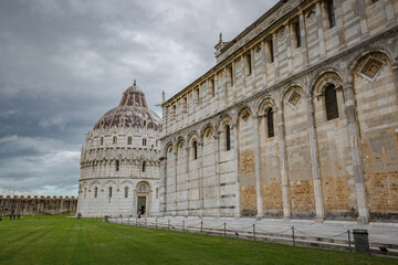 Fototapeta na wymiar View of The Pisa Baptistery and The Pisa Cathedral (Duomo di Pisa) on Piazza dei Miracoli in Pisa, Tuscany, Italy.
