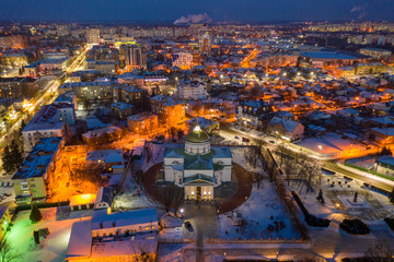 Beautiful evening top view of the city. Evening, night illumination in the city. Winter city in the snow.