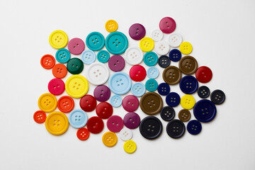 Assortment of colorful buttons on white background