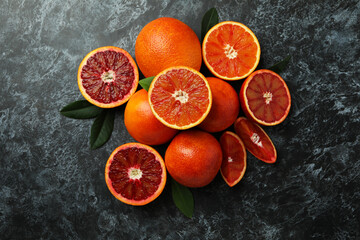 Red oranges and leaves on black smoky background