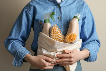 Woman hold bag with eco friendly cleaning products