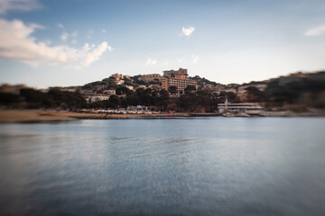 Fototapeta premium Some hotels and buildings on a sea coastline on a blue sunny sky in Costa Brava, Catalonia