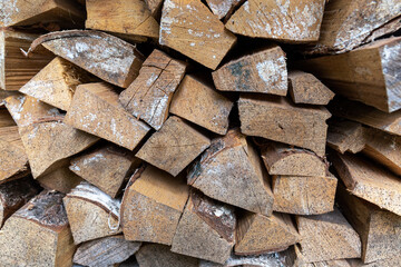Woodpile. Firewood prepared for heating the premises in the cold season. Close-up.