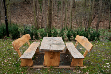 wooden benches and a table in the park