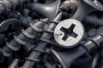 A handful of self-tapping screws for wood. Construction abstraction. Industrial background.