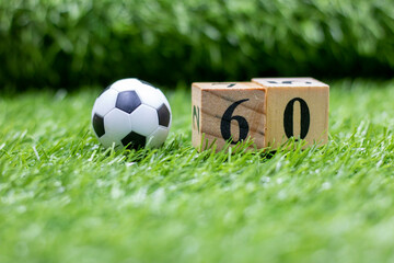 Soccer 60th Birthday with ball and number sixty on green grass
