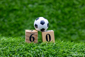 Soccer 60th Birthday with ball and number sixty on green grass