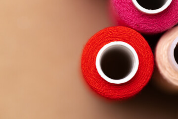 Many colored spools of threads as a background