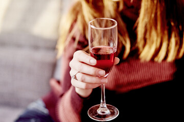 Girl with a glass of wine in the evening light