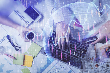 Multi exposure of man's hands typing over computer keyboard and forex graph hologram drawing. Top view. Financial markets concept.