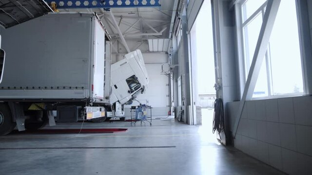View of the repair area with white trucks and refrigerator trucks at the lorry service station. Equipped dealership