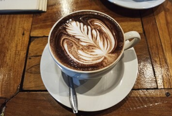 Cappuccino coffee with white cup, closeup top view with dark brown background, Cafe and bar. barista art concept