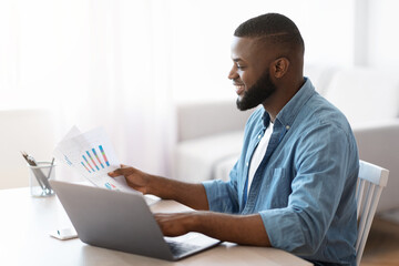 Remote Business. Black Entrepreneur Working With Papers And Laptop At Home Office