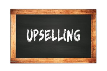 UPSELLING text written on wooden frame school blackboard.