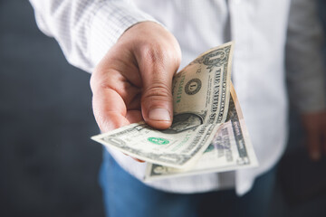 man keeps money and gives to another