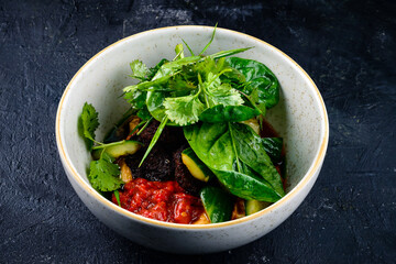 Falafel and fresh vegetables salad on dark background. Vegetarian, diet food concept.