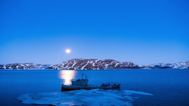Abandoned ship in Arctica inder Moon and stars winter