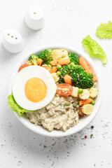 Healthy breakfast savory egg oat vegetables bowl. Space for text, top view.