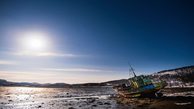 Abandoned ship in Arctica inder Moon and stars winter