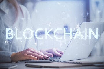 Double exposure of woman hands typing on computer and crypto market theme hologram drawing. Blockchain concept.