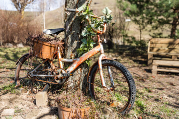 Fototapeta na wymiar Bike artificial imitations adorned with beautiful flowers on the grass.