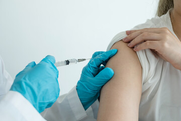 Female doctors vaccinated with syringes to prevent epidemics at hospitals, health care, and medical concepts