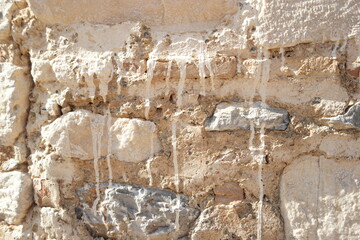 Old stone wall surface texture background. Historical architecture close up.