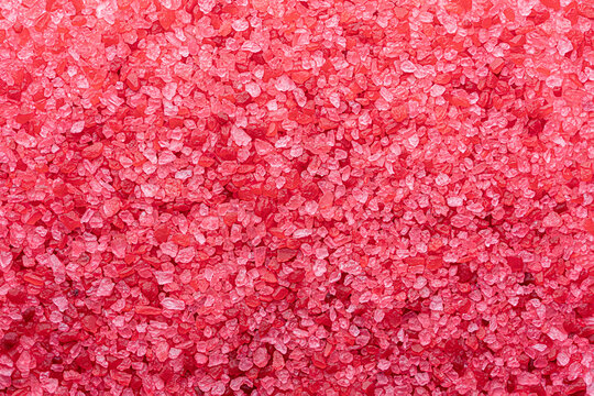 Red Salt Background, Crystal Texture. Bath Salt Close Up Flat Lay