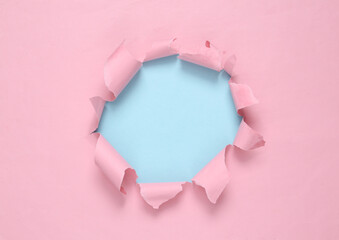 Broken hole paper. Blue-pink background. Pastel color trend. Copy space