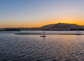 Panoramic view of sailing boats on the Nile river in Aswan, Egypt during the Golden Hour
