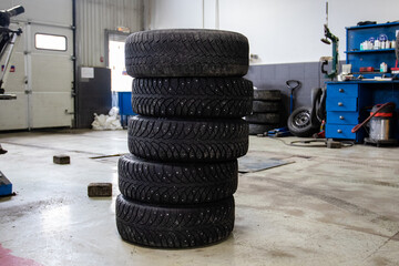 Five car tires at a tire service. Tire fitting company