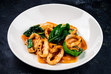 Stewed squid rings in sauce for Healthy mediterranean dinner.