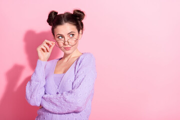Photo portrait of model in glasses wearing stylish violet cardigan looking empty space isolated on pastel pink color background
