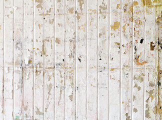 Urban background, white ruined industrial wall with creased crumpled placard.