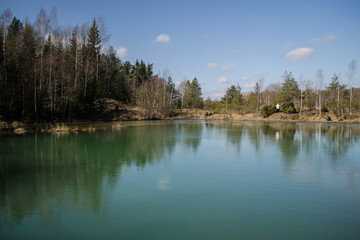 Fototapeta na wymiar View of small green blue Lackroga lake, Latvia