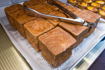 A traditional square loaf of bread is isolated.