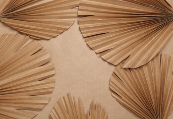Decor dry palm leaves on beige background. Creative background. Copy space