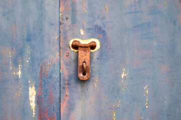 Old lock of the metal door.  Rusty old metal texture with remnants of the paint. Grungy background for any design. 